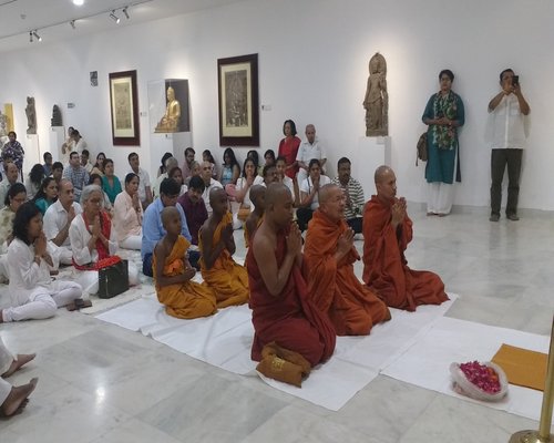 Group meditation session showing various traditional meditation postures